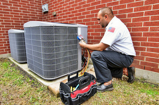 Technician repairing an air conditioner