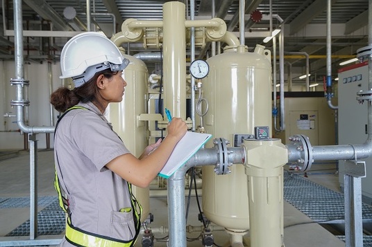 Woman technician working on a refrigerating equipment