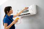 Technician repairing an air conditioner